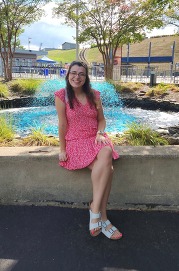 Teacher sitting on down in front of a fountain