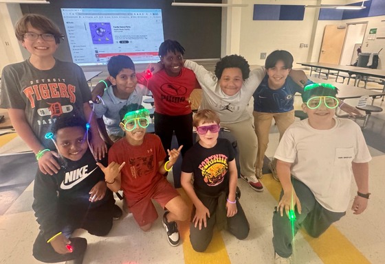 Fifth grade students in glow glasses.