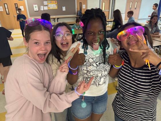 Students with glow glasses and bracelets on.