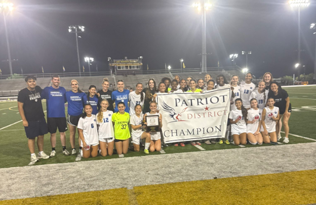 Student soccer team standing on a field