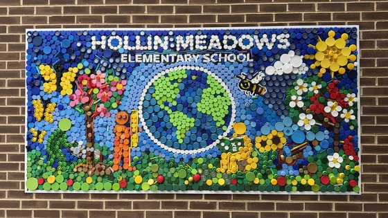 A colorful mural on the wall of Hollin Meadows created using plastic bottle caps.
