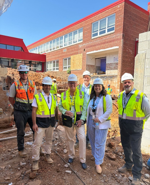 Dr. Reid and Dr. Vereb in construction site with workers