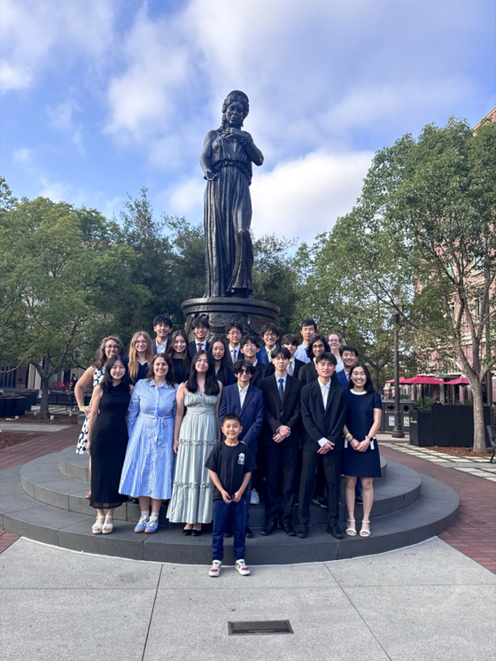 TJ's Science Olympiad Team posing in front of a statue on the campus of the University of Southern California
