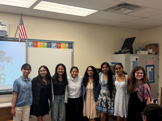 Students in a classroom posing for a picture