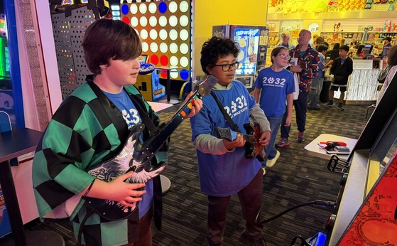 two students playing a guitar game