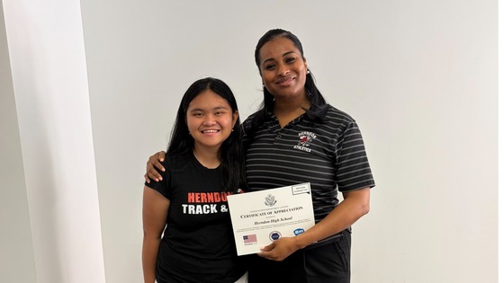 Foreign Exchange student presenting Dr. Farrish with a certificate
