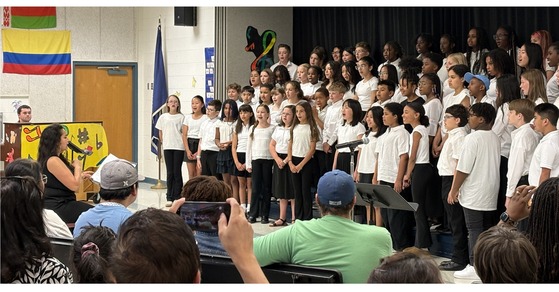 The Lane 5th and 6th grade choruses on the stage in the Cafeteria