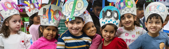 Group of kindergarten students hugging and smiling