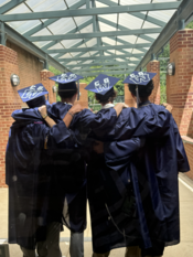 Woodson graduates in their caps and gowns.