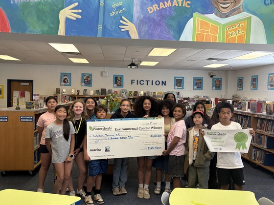 students holding prize check
