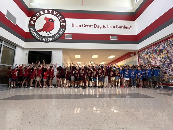 kindergarten students under the forestville logo