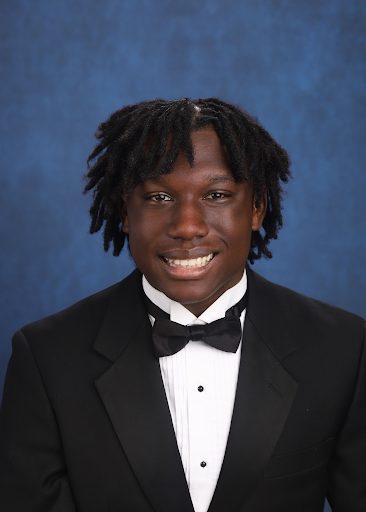 Male student in a tuxedo smiling