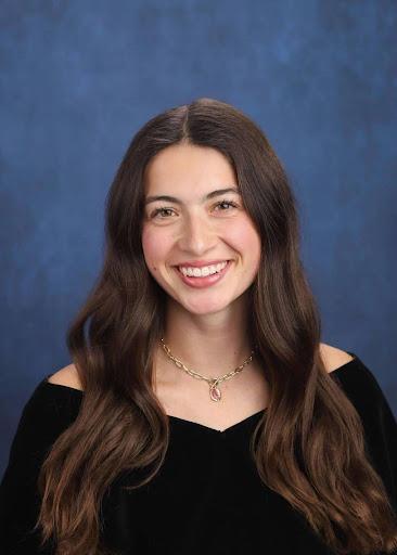 Female student in black dress smiling at the camera