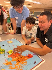 A student and his family members look at a map of the world.