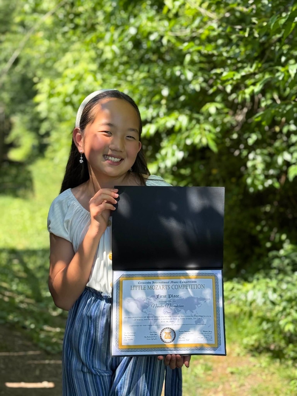 student holding award