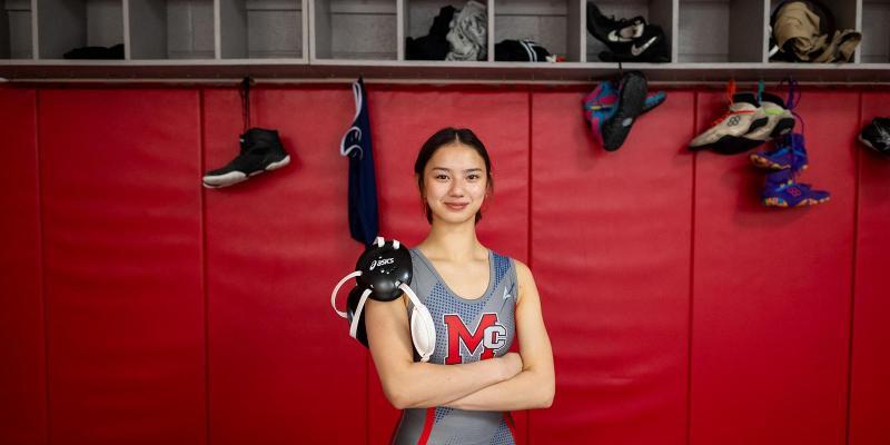 Student standing in Wrestling Room