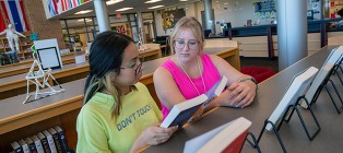school library w two teen girls