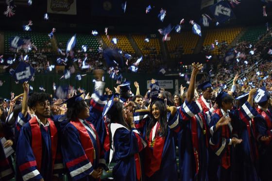 TJ Class of 2026 students throwing their caps into air at end of ceremony