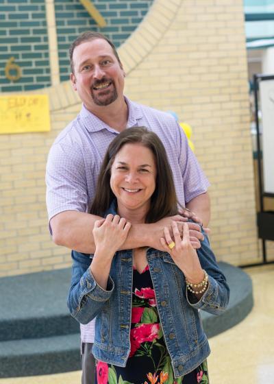 Mr. and Mrs. Antoncic pose for a photograph in front of the clock in the lobby.