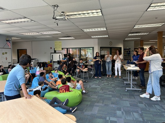 Teachers talking to students in the school library