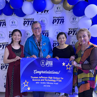 Members of TJ's PTSA and Superintendent Dr. Reid pose with banner congratulating TJ PTSA winning the award.