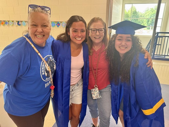 Two Robinson seniors posing with their kindergarten teachers