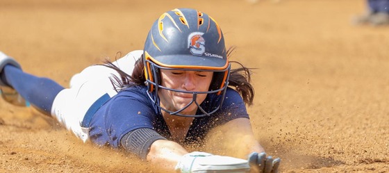 softball player sliding into plate