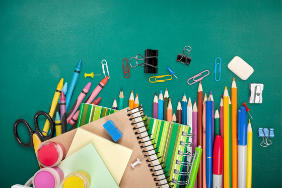 school supplies spread out on a green background