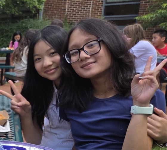 Two smiling students enjoying time at one of the last lunches of the school year together.