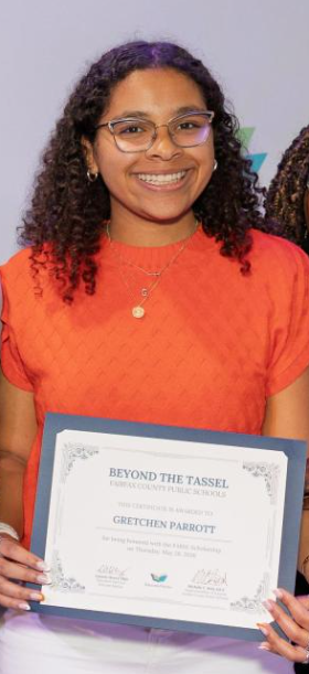 Female student standing while smiling