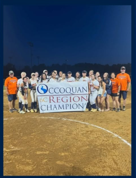 Softball team standing together smiling while holding Occoquan Region Champions banner