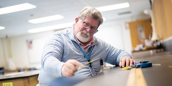 teacher writes something down on paper