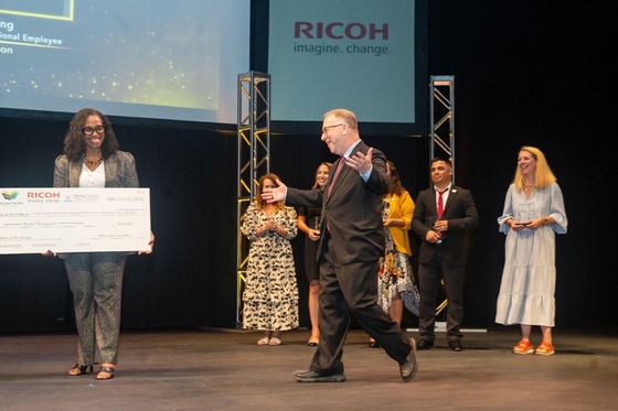 award winner walks across the stage to get award from Dr. Reid