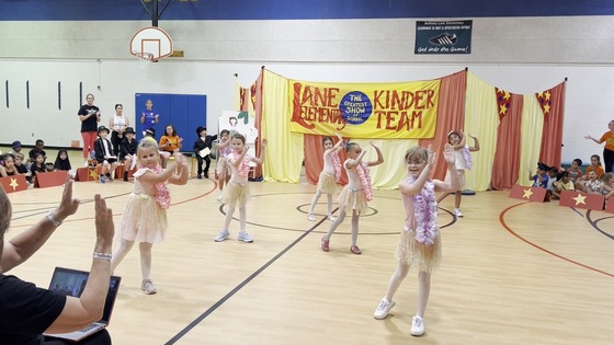 Students dressed as hula dancers performing in the Kindergarten Circus