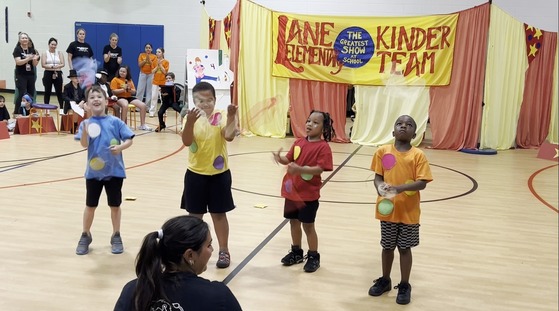 Students performing as jugglers in the Kindergarten Circus