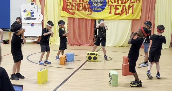 Students dressed as breakdancers performing in the Kindergarten Circus