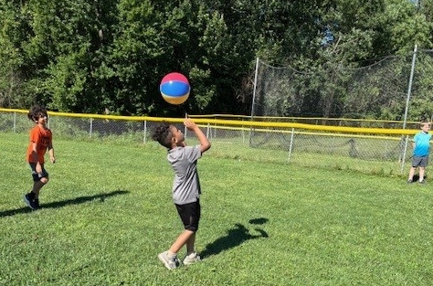 student playing with a ball