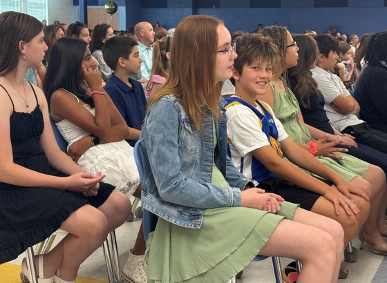 Students sitting during 6th grade promotion