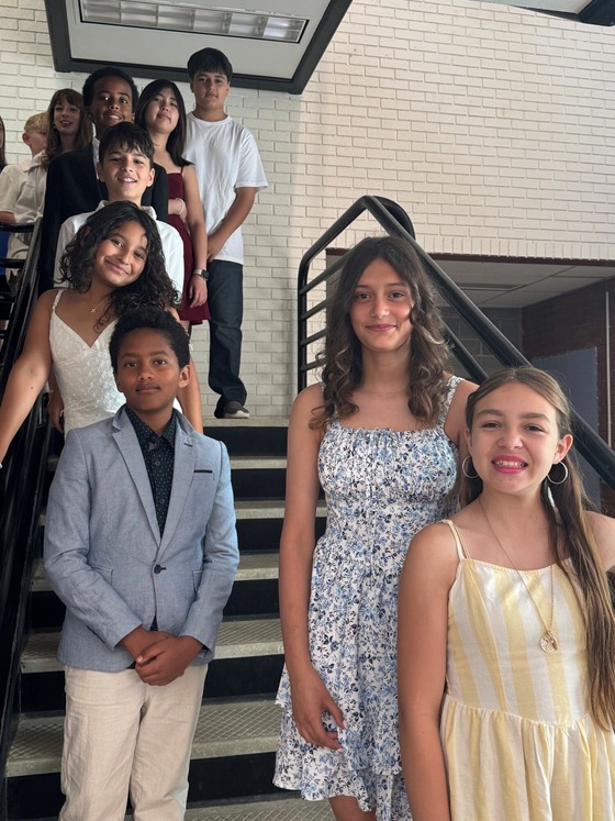 Students standing in stairwell waiting for the 6th grade promotion