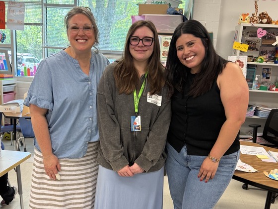 Two teachers with the teachers for tomorrow student intern