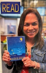 Mrs. Antoncic holding her favorite book.