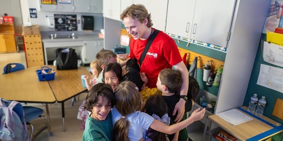 Ilia Malinin hugs students