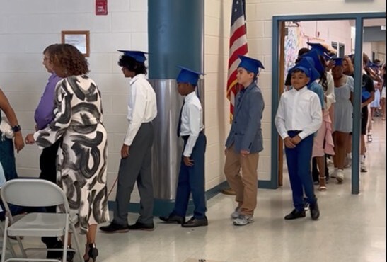 6th grade students parading into the cafeteria
