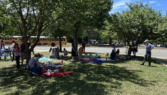 2nd grade families enjoying a picnic in the bus loop courtyard