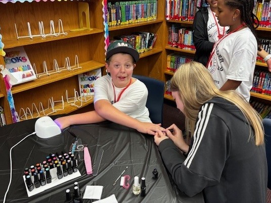 Cardinal Forest 6th Grader getting nails done by Cosmetology Academy students 