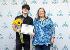 New Student Rep Newt Shosteck and Marcia St. John-Cunning in front of FCPS Background
