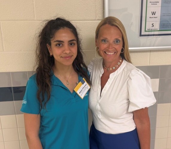 Two people pose for a picture