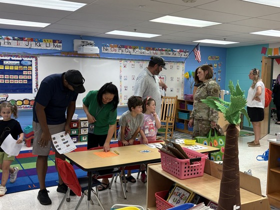 Families explore a classroom, complete activities, and talk with staff during Greenbriar East’s Open House.
