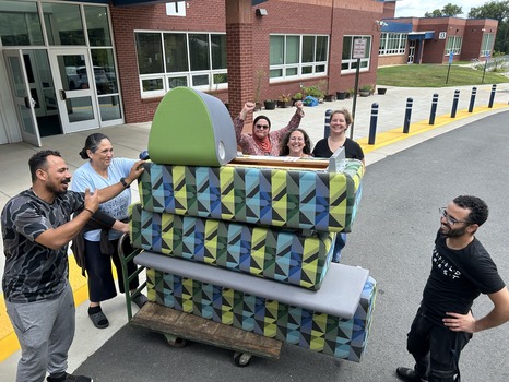 Staff unloading furniture from uhaul