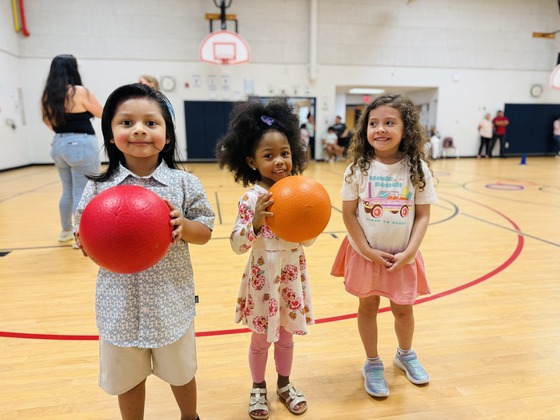 Three future Bucknell kindergartners enjoying their Kindergarten Playdate in the school gym.